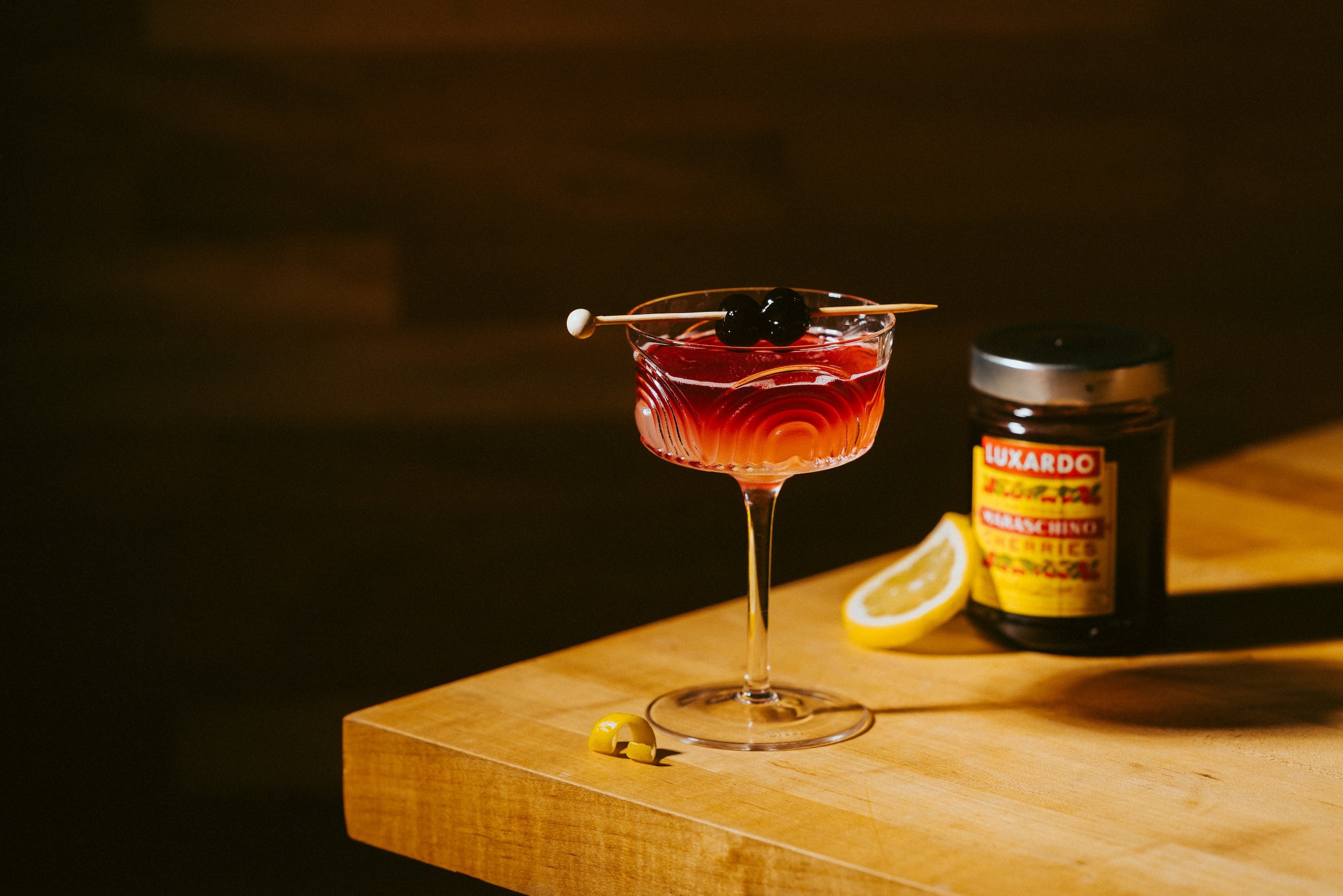 New York Sounr cocktail on table top with cherries by Zero Non-Alcoholic Bar
